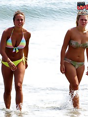 Girls sliding their wet bikinis down