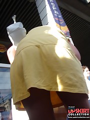 Yellow mini cannot save her from being voyeured. Up skirt upskirt no panties