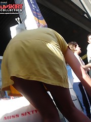 Yellow mini cannot save her from being voyeured. Up skirt upskirt pussy