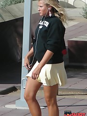 Young blonde in white mini on the street. Real upskirt upskirt picture
