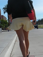 Young blonde in white mini on the street. Real upskirt up skirt pic