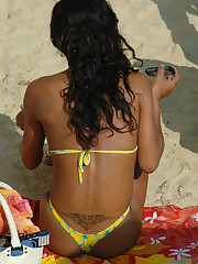 A busty bikini lady undressing on the Natadola upskirt pantyhose