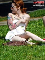 Tattooed redhead voyeured in a park. Sexy upskirt candid upskirt