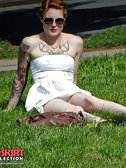 Tattooed redhead voyeured in a park. Sexy upskirt upskirt pantyhose