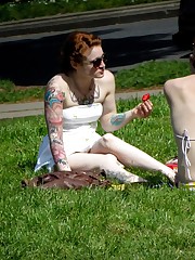 Tattooed redhead voyeured in a park. Sexy upskirt upskirt shot