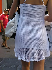 Panty upskirt - brunette in white dress voyeured upskirt photo