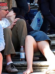 Peek between crossed legs of hot gal up skirt pic