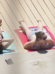 Girls in bikinis relax under sun upskirt photo